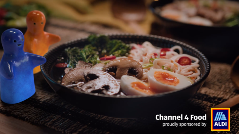 Smiling figurine next to a bowl of food
