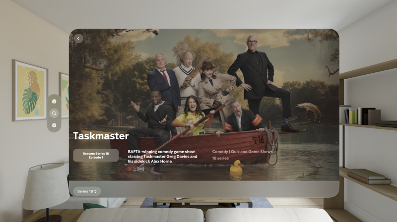 A screen shot of an Apple simulated screen that has the branding of Taskmaster on it. Beneath it says Resume Series 18 Episode 1 and then to the left BAFTA-winning comedy game show starring Taskmaster Greg Davies and his sidekick Alex Horne. In the background is the key art from this series where the comedians alongside Alex Horne and Greg Davies are all on a little rowing boat.
