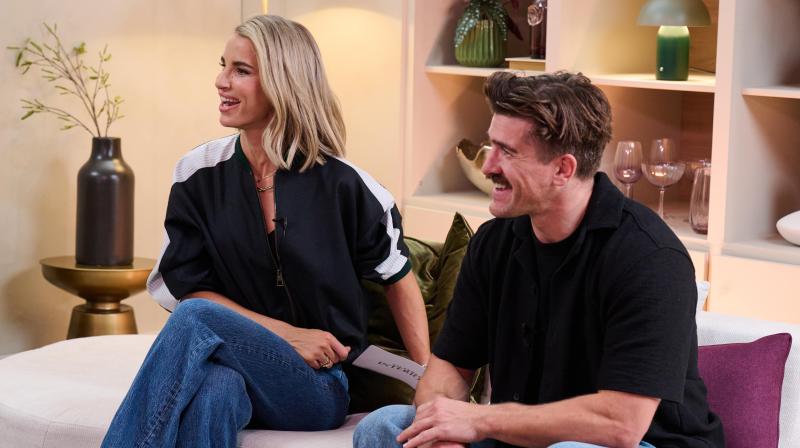 It shows Vogue Williams and Danny Campbell sitting on a coach and chatting to someone slightly off camera