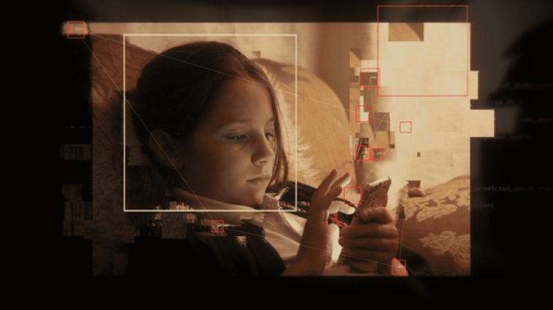 Photo of younger Molly Russell looking at her phone