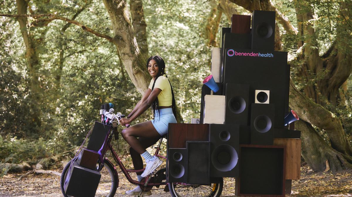 AJ Odudu riding a bike in Benenden Health advert on Channel 4 