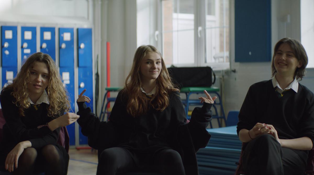 A picture of three girls in school uniform sat on chairs - a still from Vanish's winning Diversity In Advertising Award campaign