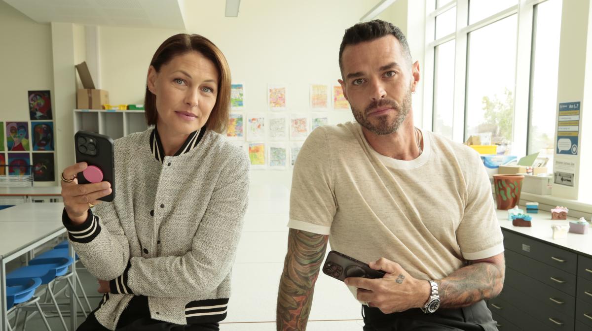 Emma and Matt Willis holding smartphones