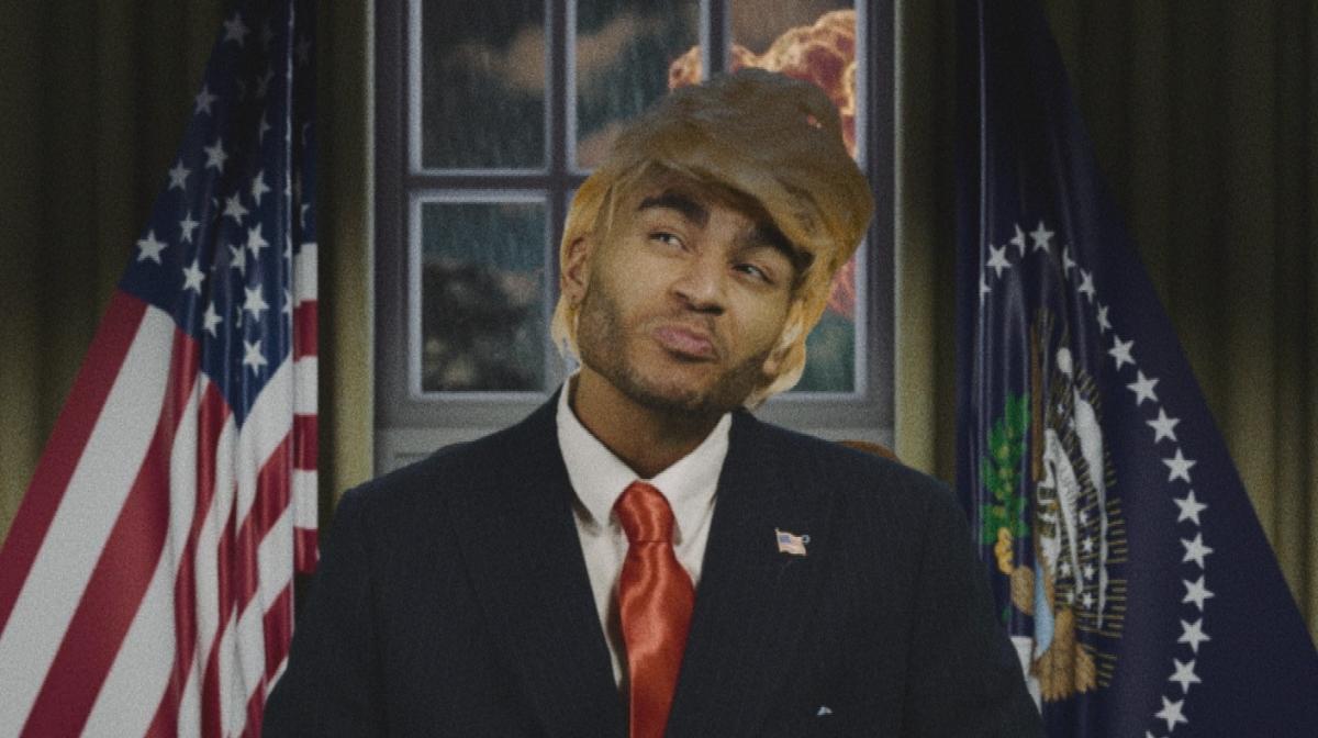 Munya Chawawa dressed in a Donald Trump wig and suit in How To Survive a Dictator: North Korea