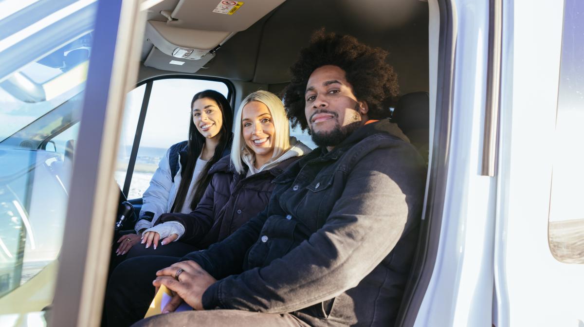 An image of the three teachers taking part in the series sat in a van