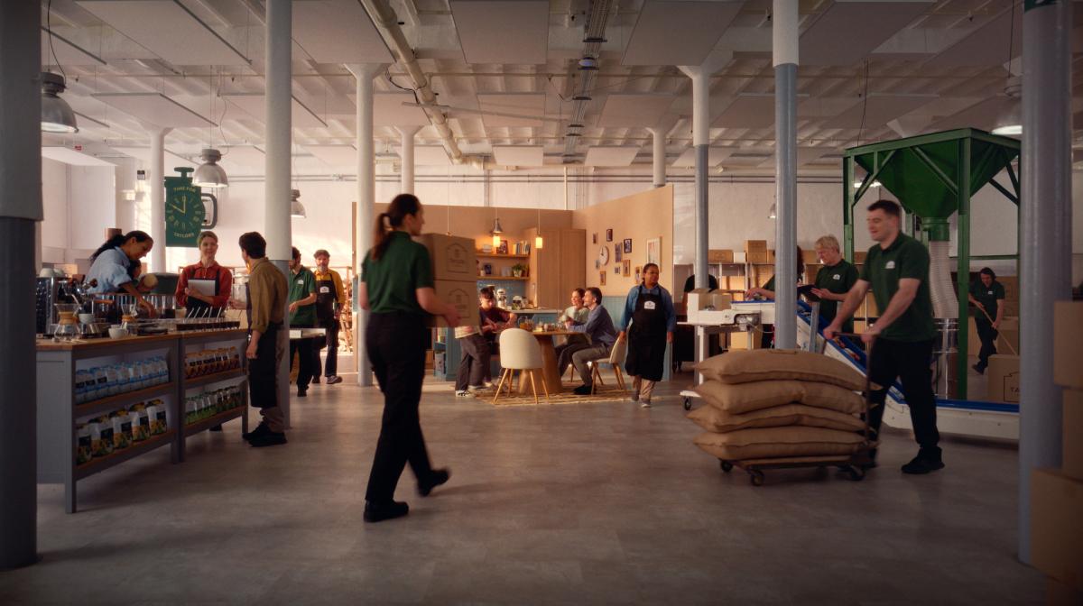 A scene inside the Taylors of Harrogate factory, with a family enjoying their Sunday breakfast in the background.