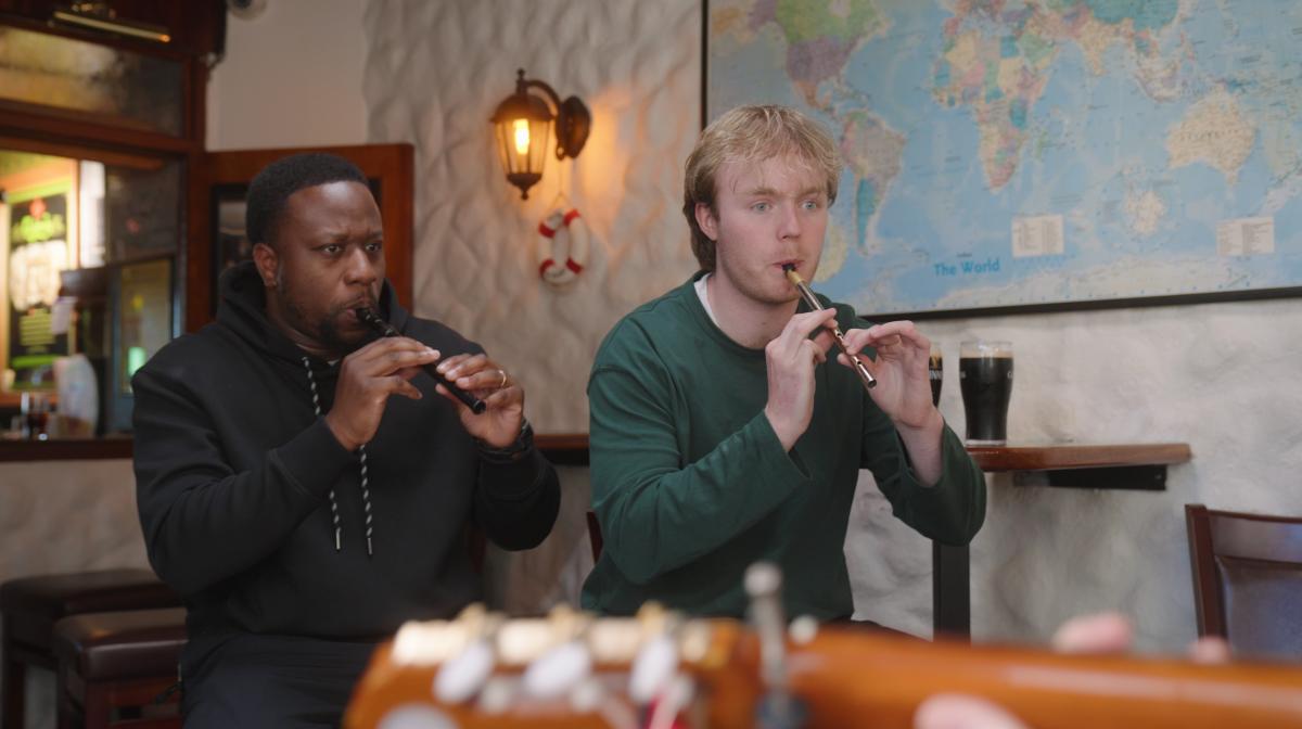 Babatunde Aleshe and Finlay Christie practicing a wind flute 