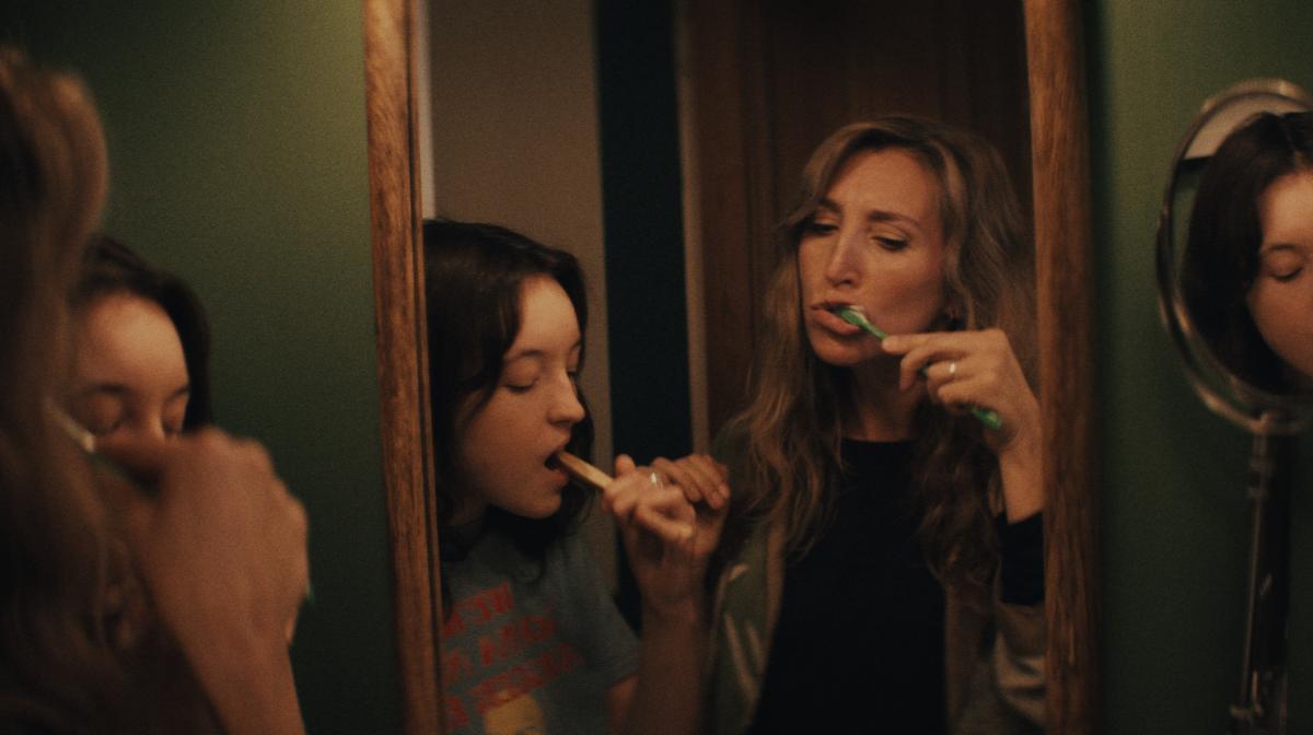 Image of Daisy Haggard and Bella Ramsey brushing their teeth