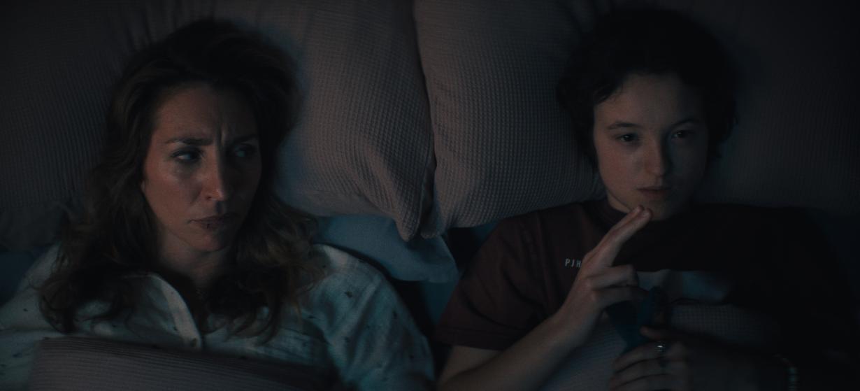 Daisy Haggard and Bella Ramsey lying on their pillows in bed