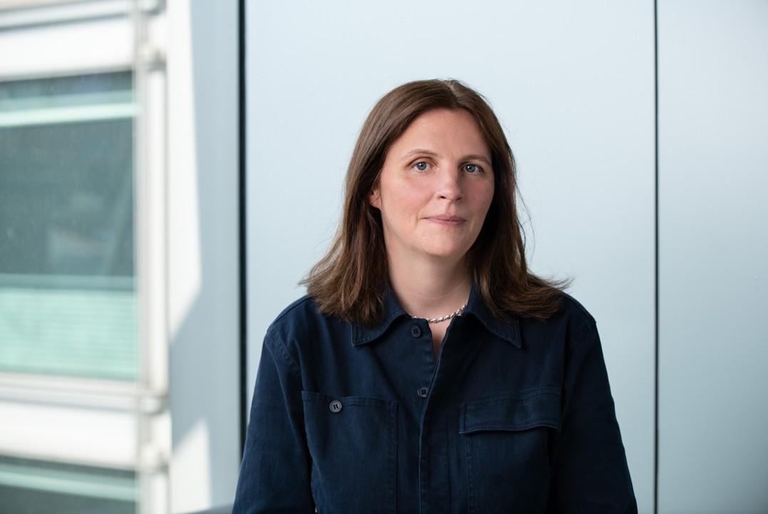 An image of Louisa in a blue shirt smiling at the camera.