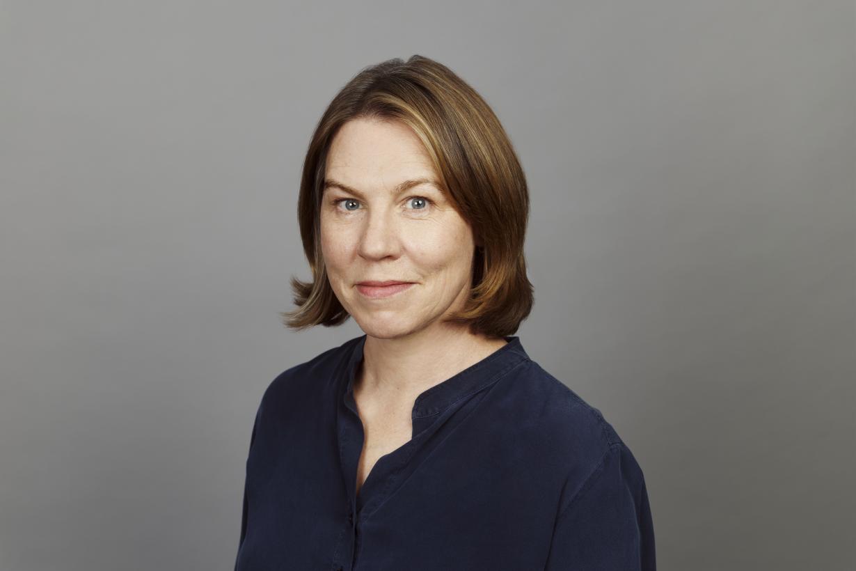 Mary in her headshot smiling at the camera.